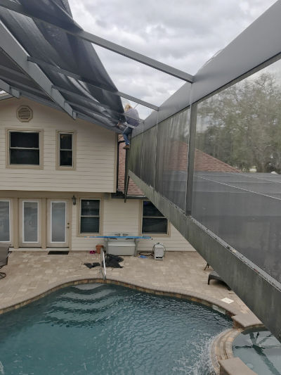 A pool screen being repaired in Middleburg, Florida
